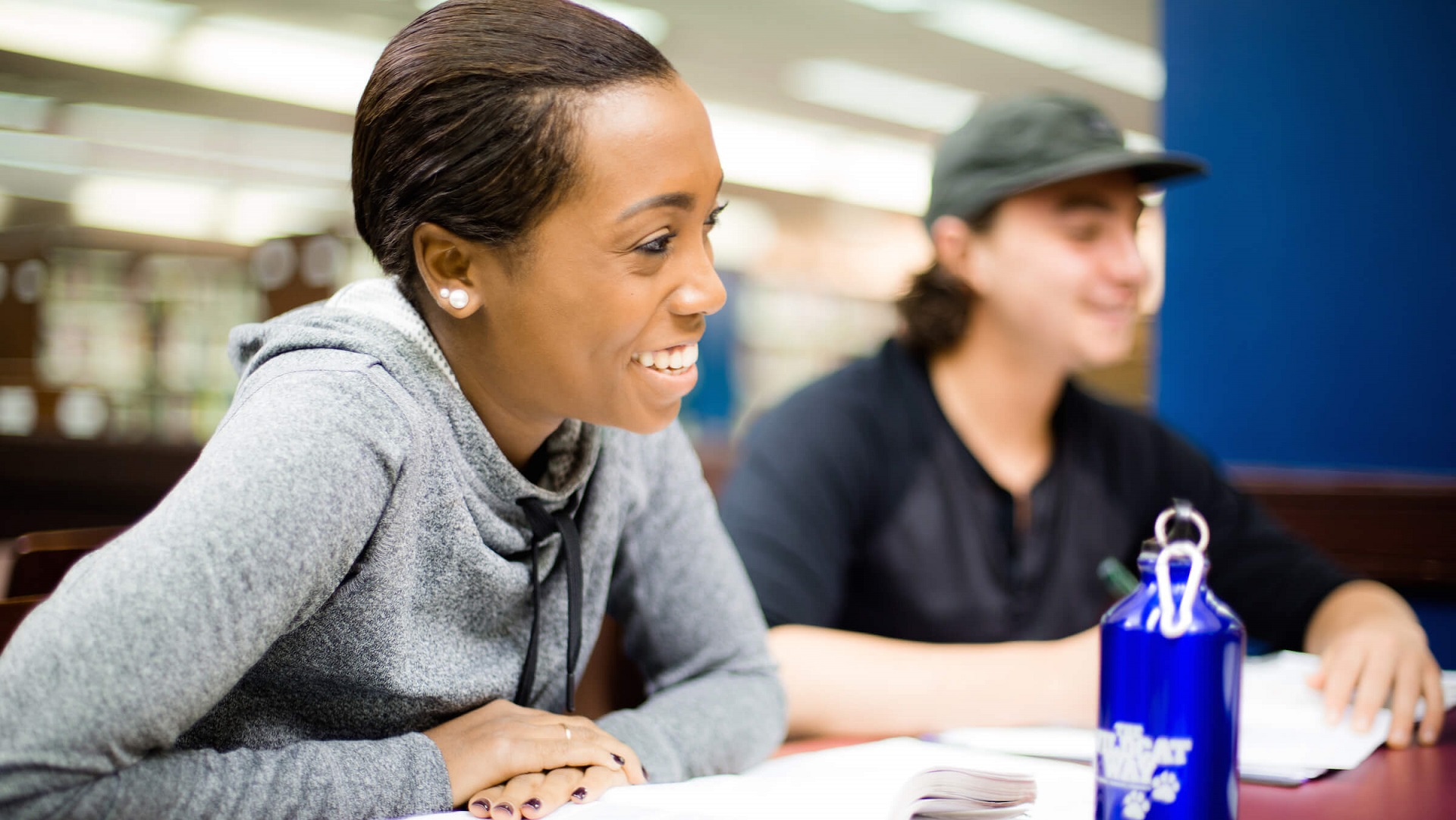 two students smiling and studying