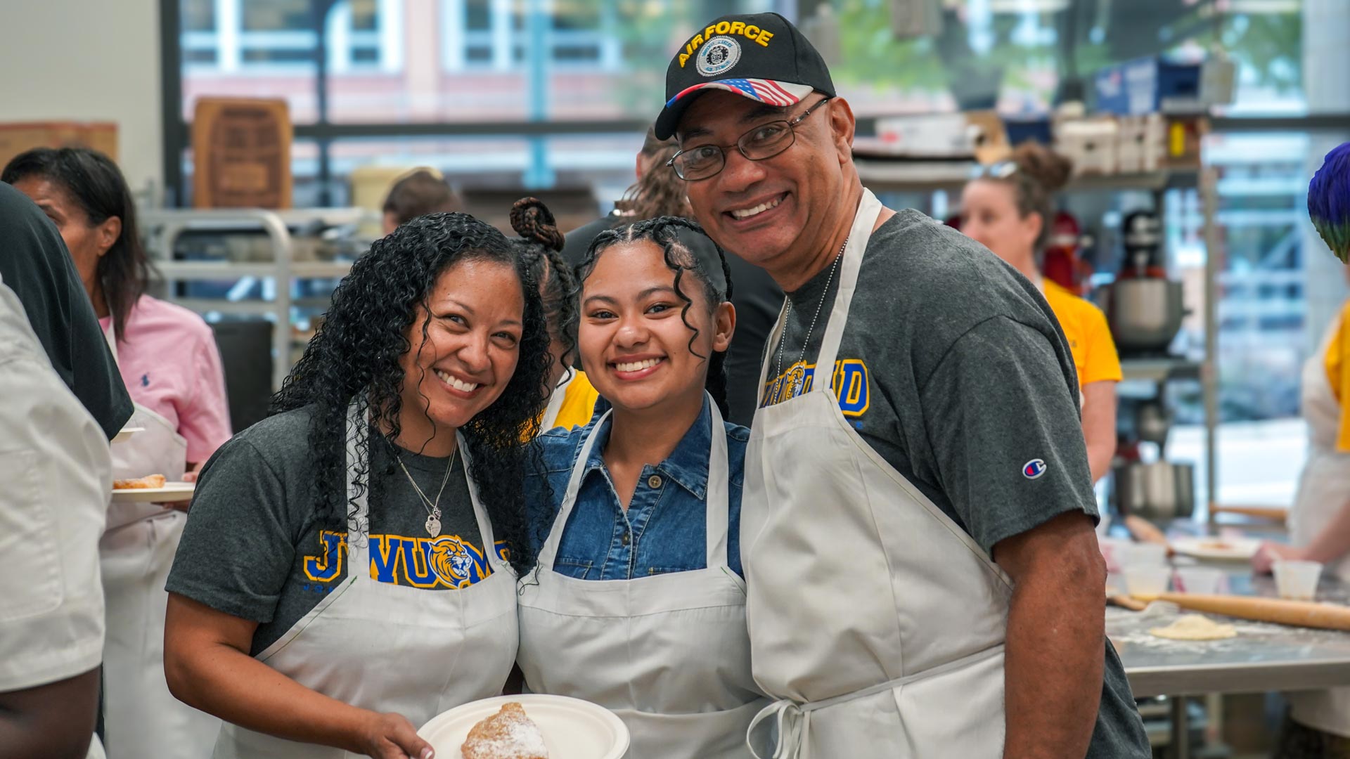 Dad, mom, and daughter smile at
